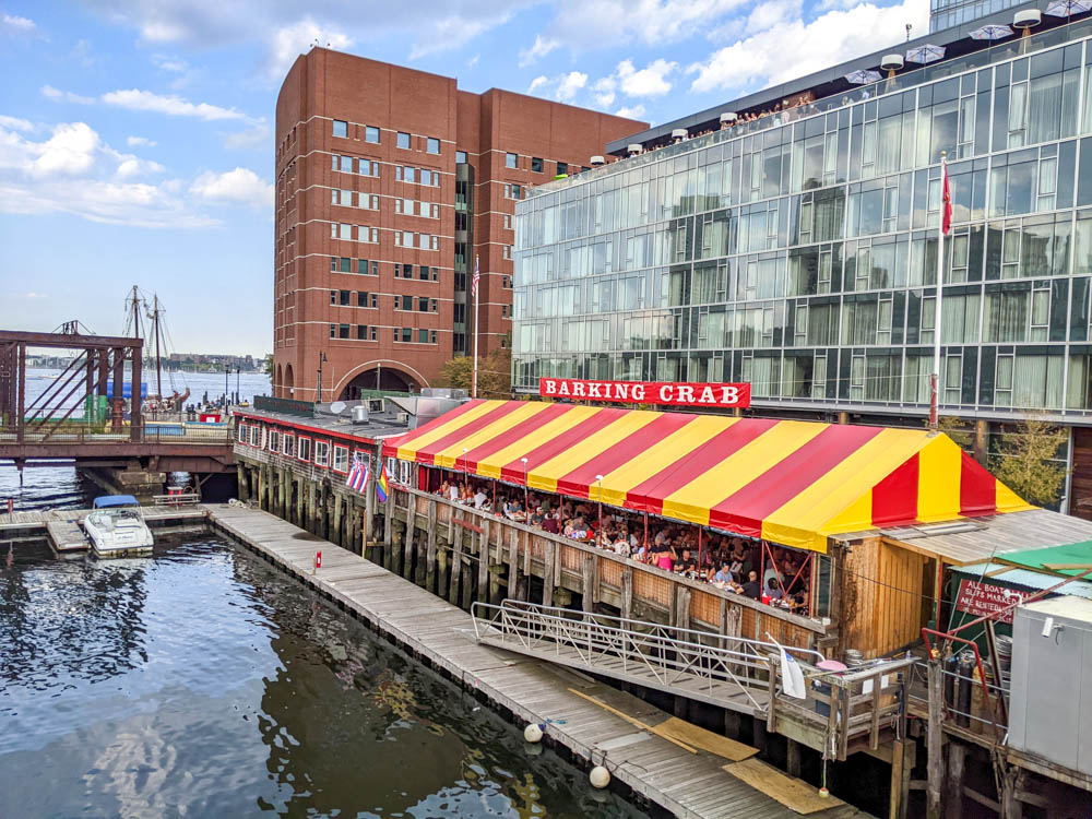 exterior shot of restaurant on the water with yellow and red striped roof