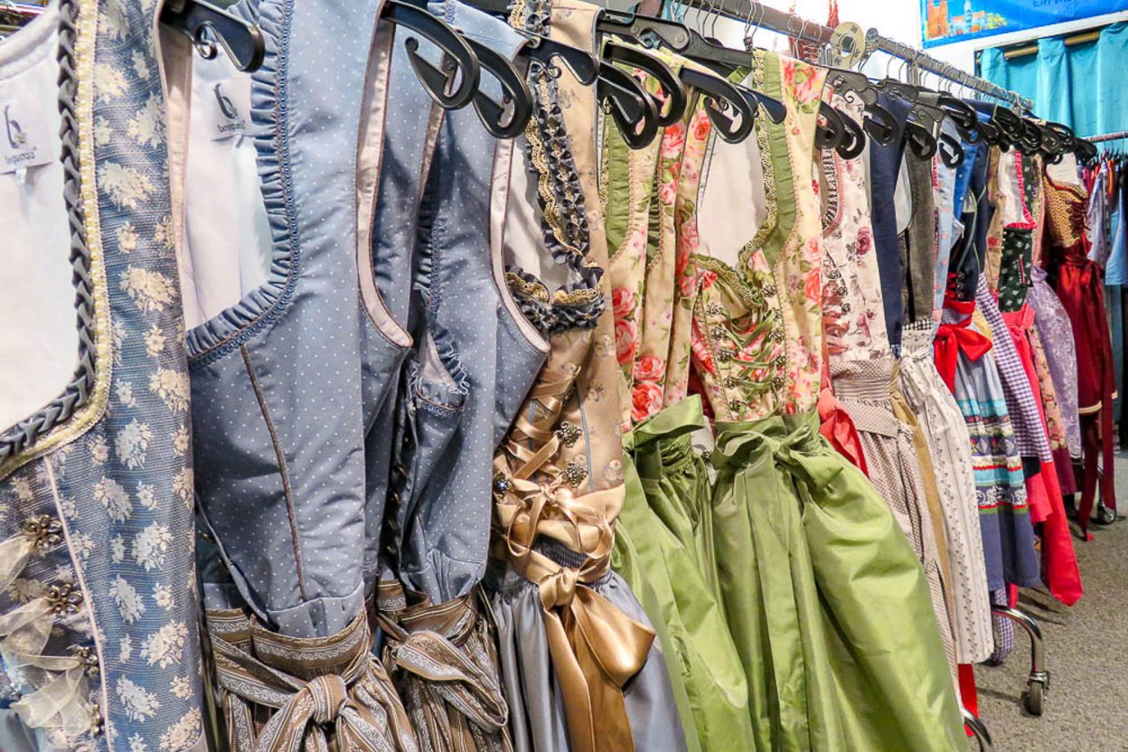 racks of beautiful dirndls in a trachten pop up shop in munich during oktoberfest