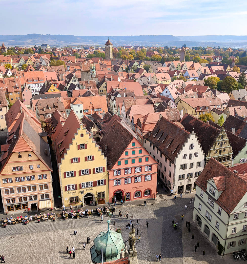 view of red rooftops and half timbered buildings from top of town hall tower