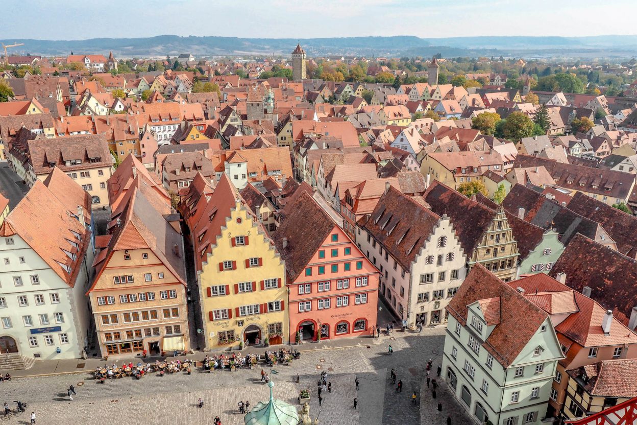 shot of the town from above with red rooftops and towers | One Day in Rothenburg ob der Tauber, Germany: What to do, see, eat, and more. | Rothenburg day trip from Munich, Frankfurt, and others. Rothenburg itinerary for summer, fall, winter, spring. Festivals, things to do, where to park, and where to stay.