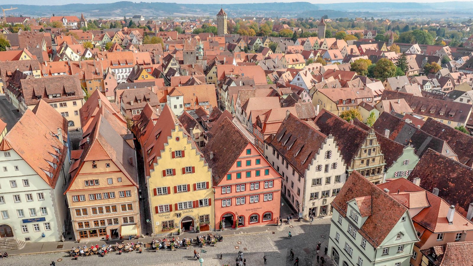 shot of the town from above with red rooftops and towers | One Day in Rothenburg ob der Tauber, Germany: What to do, see, eat, and more. | Rothenburg day trip from Munich, Frankfurt, and others. Rothenburg itinerary for summer, fall, winter, spring. Festivals, things to do, where to park, and where to stay.