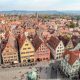 shot of the town from above with red rooftops and towers | One Day in Rothenburg ob der Tauber, Germany: What to do, see, eat, and more. | Rothenburg day trip from Munich, Frankfurt, and others. Rothenburg itinerary for summer, fall, winter, spring. Festivals, things to do, where to park, and where to stay.