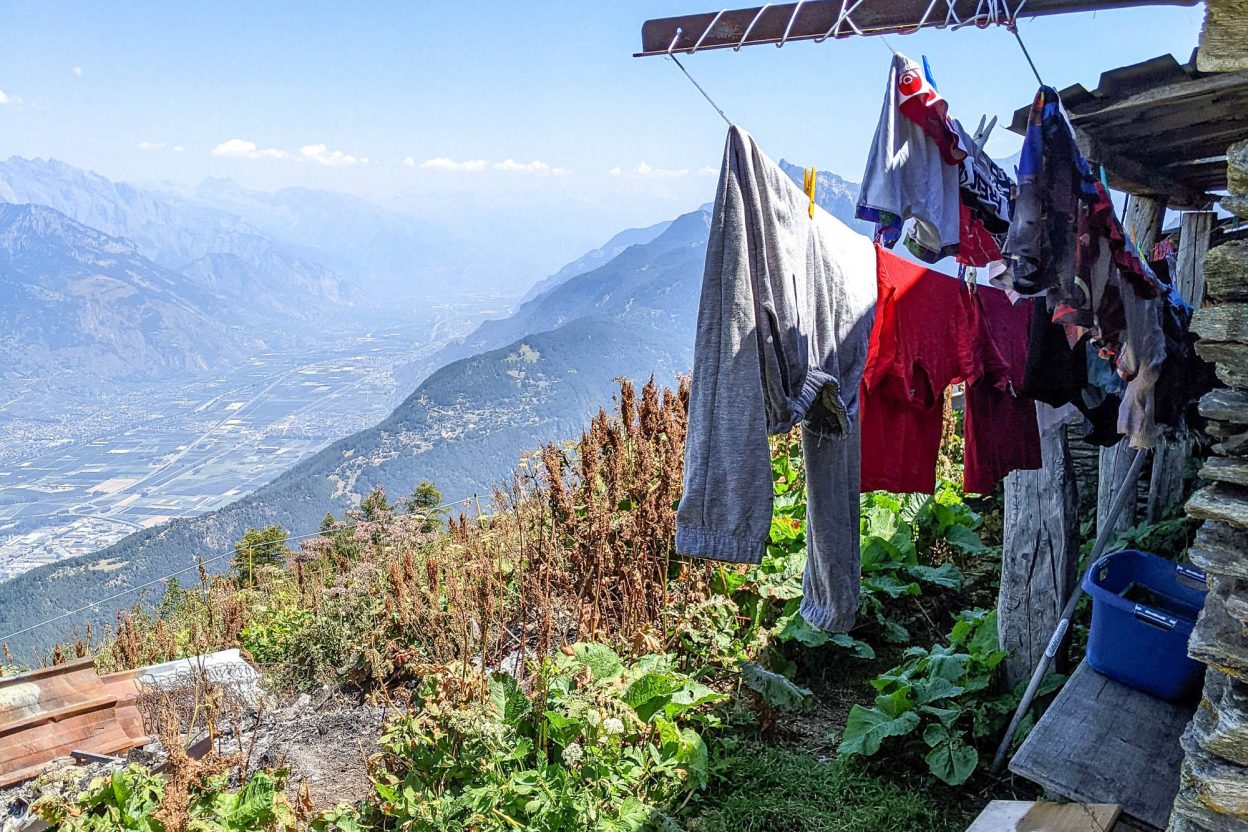 clothes hanging on a clothesline above a big mountain valley