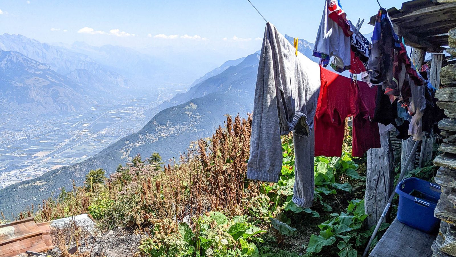 clothes hanging on a clothesline above a big mountain valley