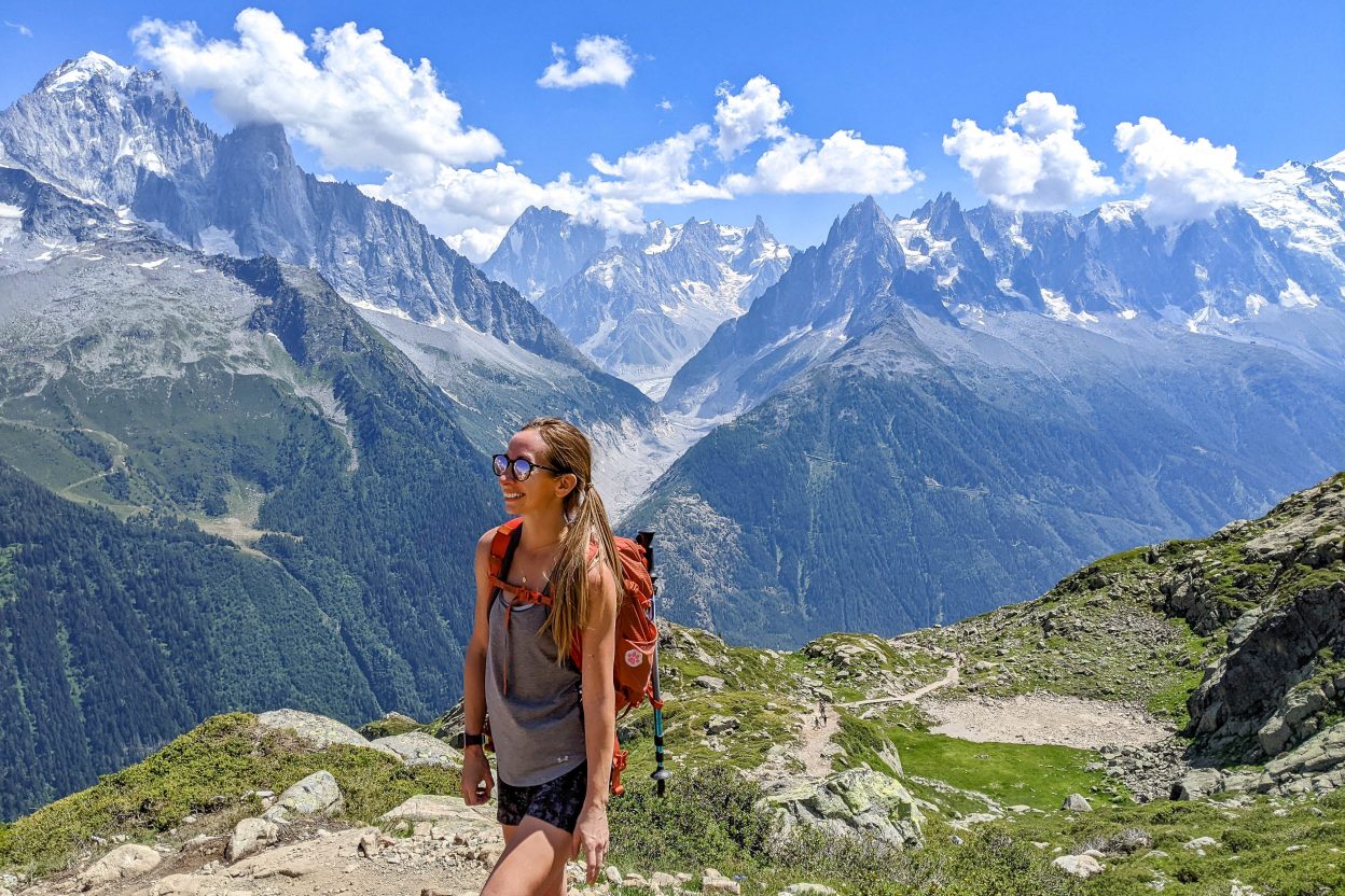 me hiking along a mountain trail while wearing an orange backpack