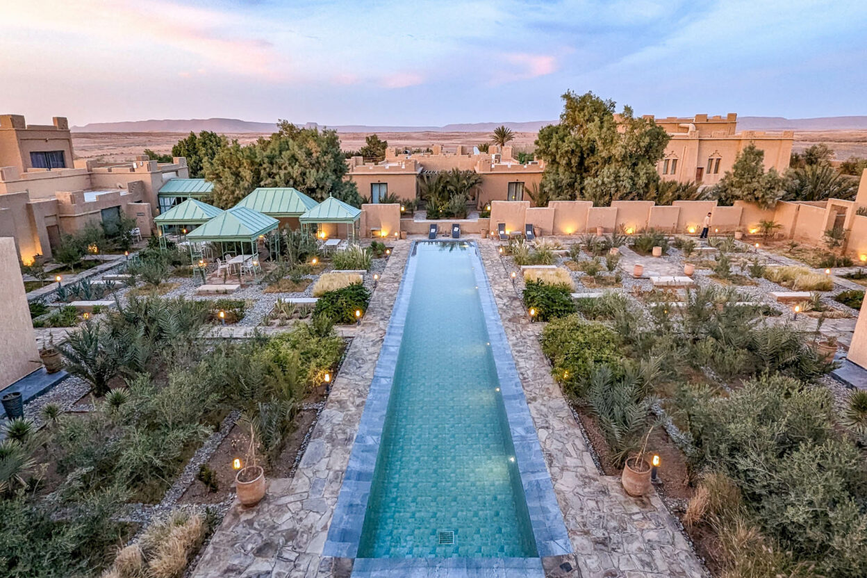 a sandcastle looking hotel with a pool down the middle as seen from above