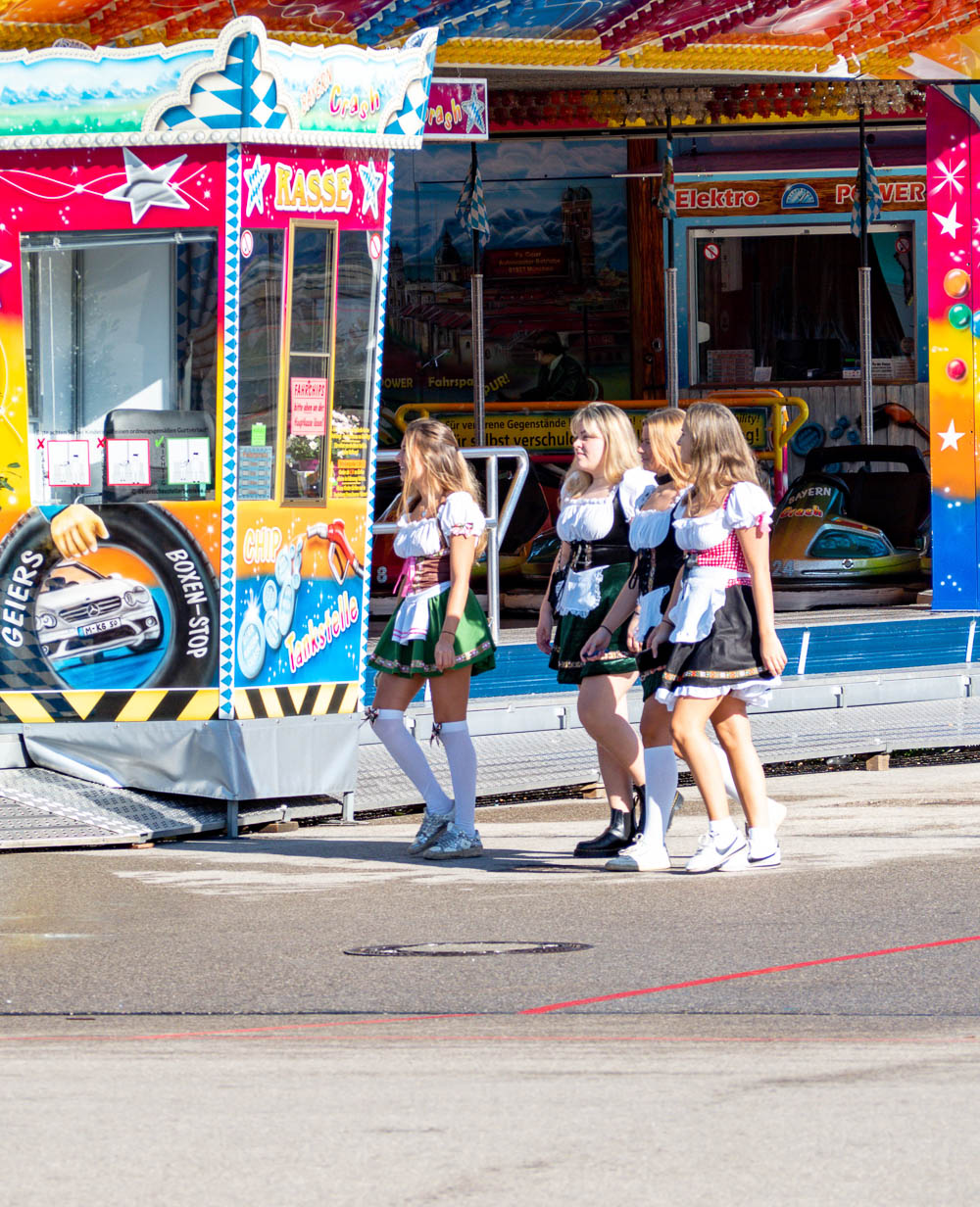 four girls at oktoberfest wearing stupid costumes