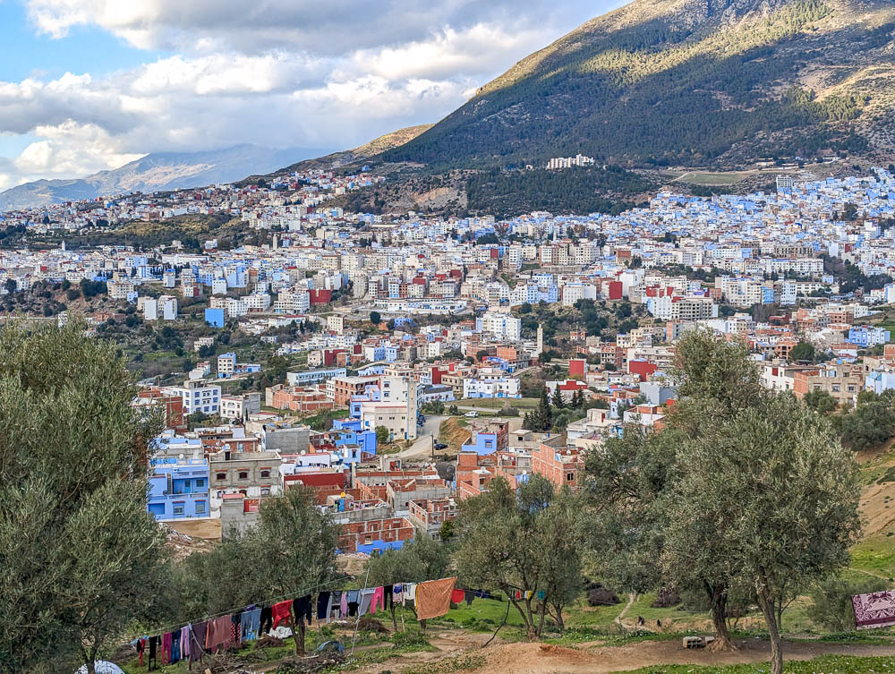 Looking out over a town with blue buildings on a mountainside