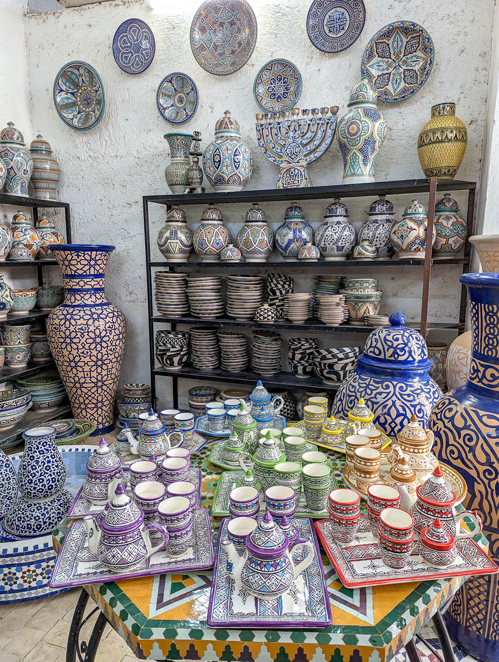 shelves of colorful pottery and vases