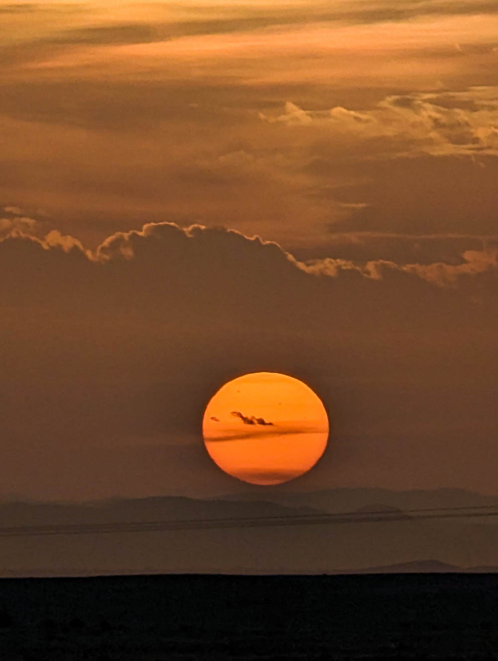 huge orange sun at sunset