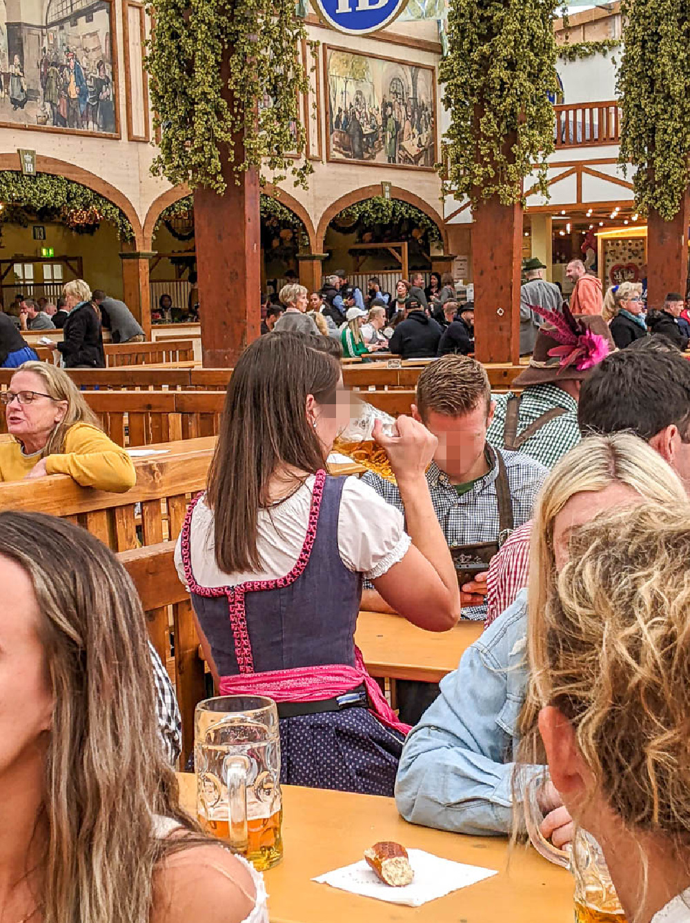 woman wearing a dirndl backwards inside a beer tent