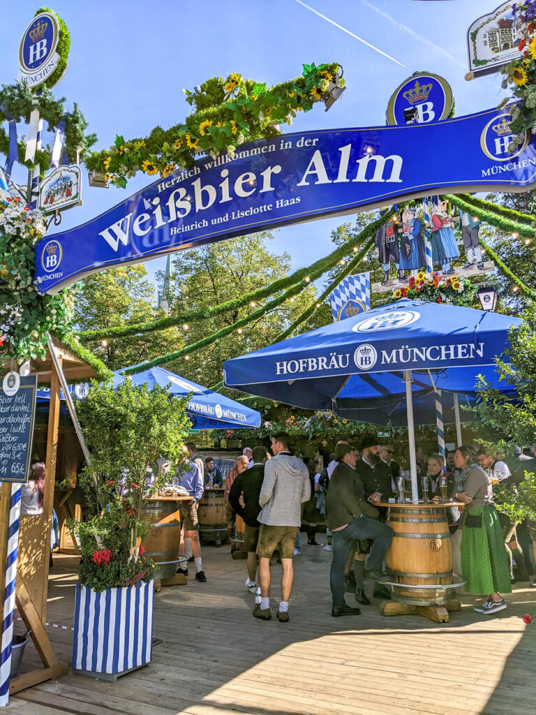 outdoor beer garden at oktoberfest with blue signs