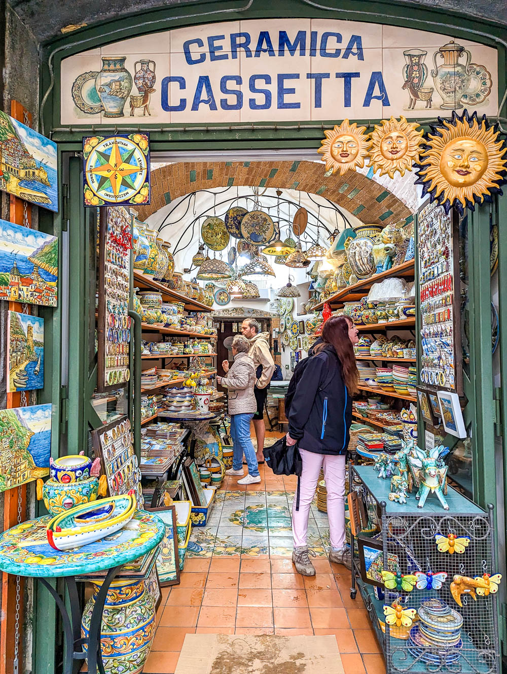 looking inside a ceramic shop with lots of colorful dishes
