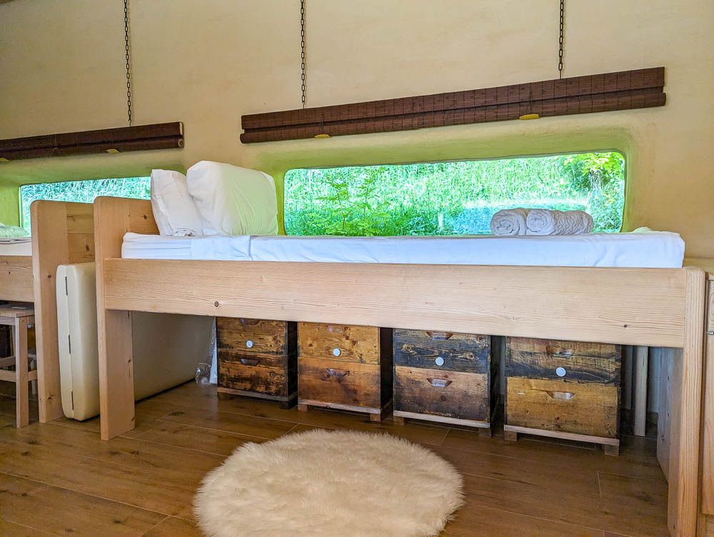 four beehive boxes under a tall bed