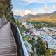 colorful town beneath a wooden walkway on the edge of a mountain