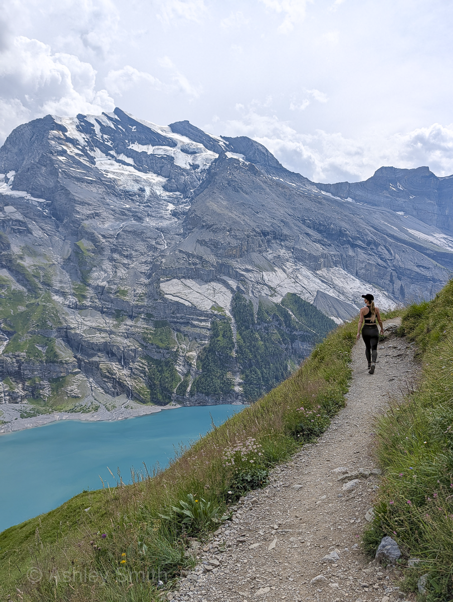 woman hiking in the mountains near a lake