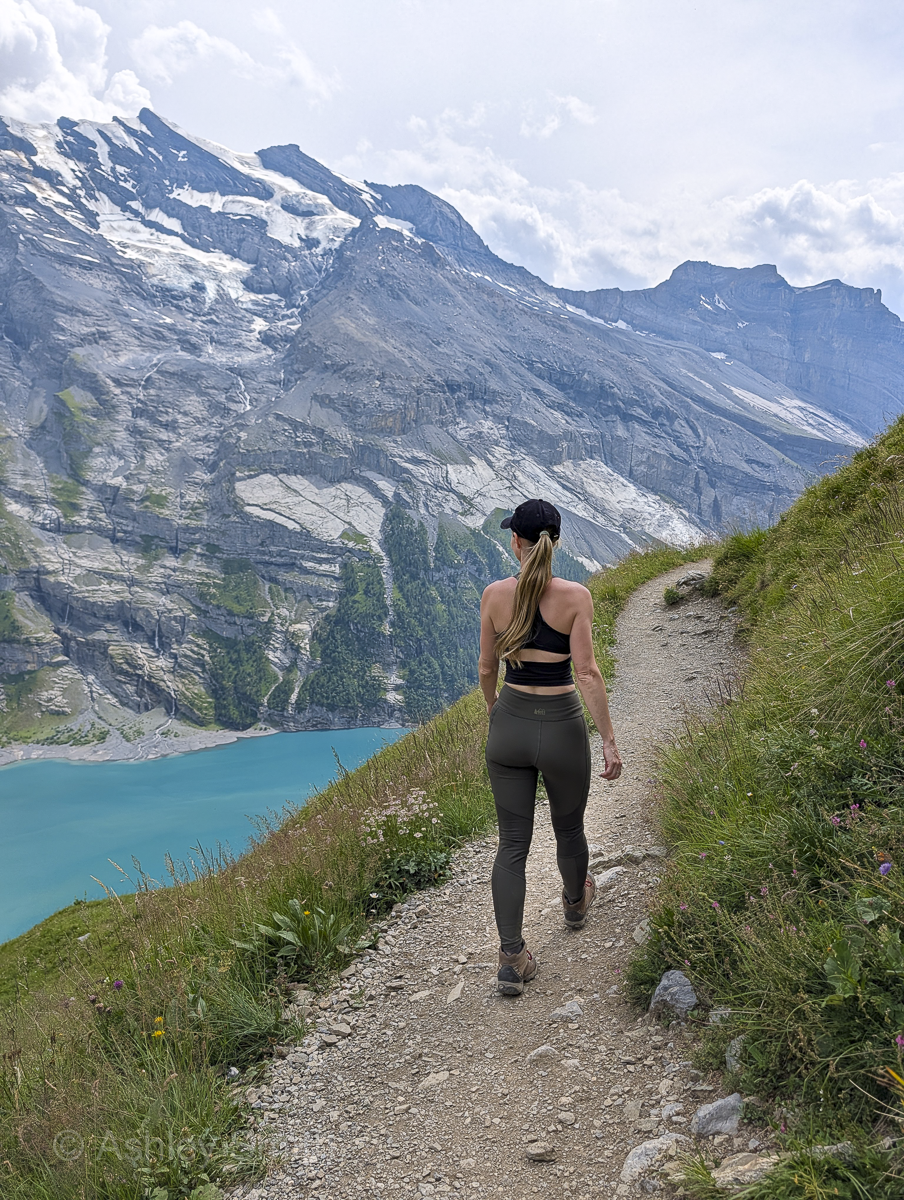 woman hiking in the mountains near a lake