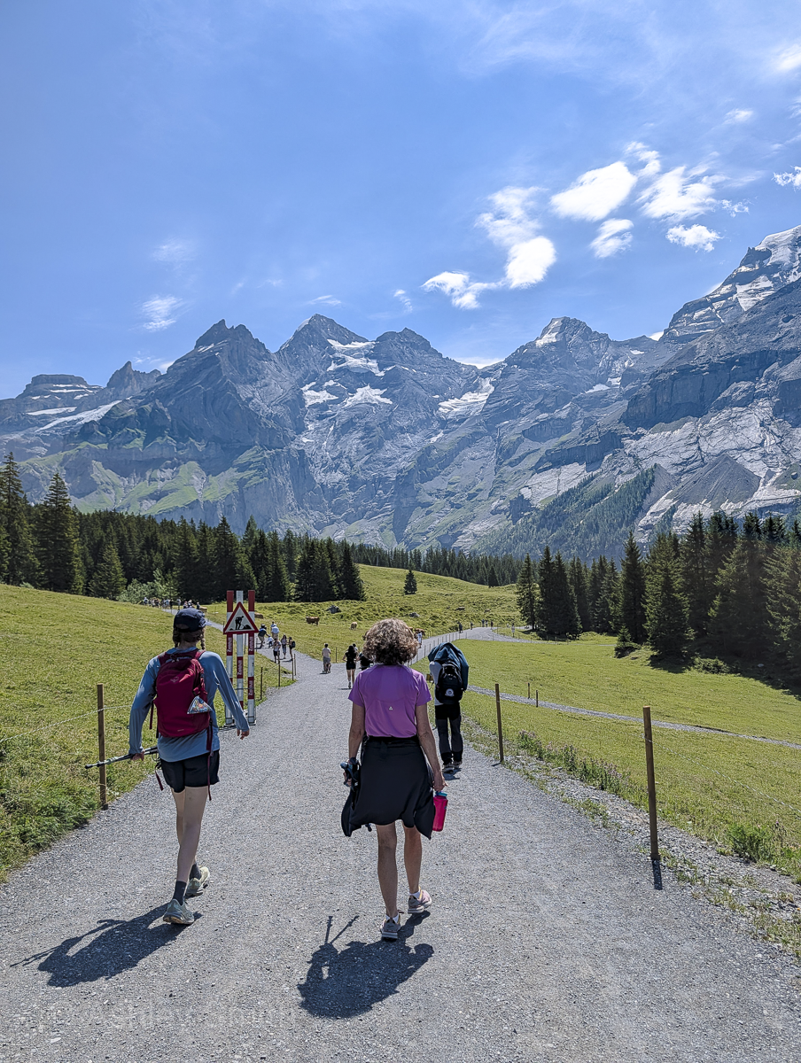 people walking on a flat path in the mountains